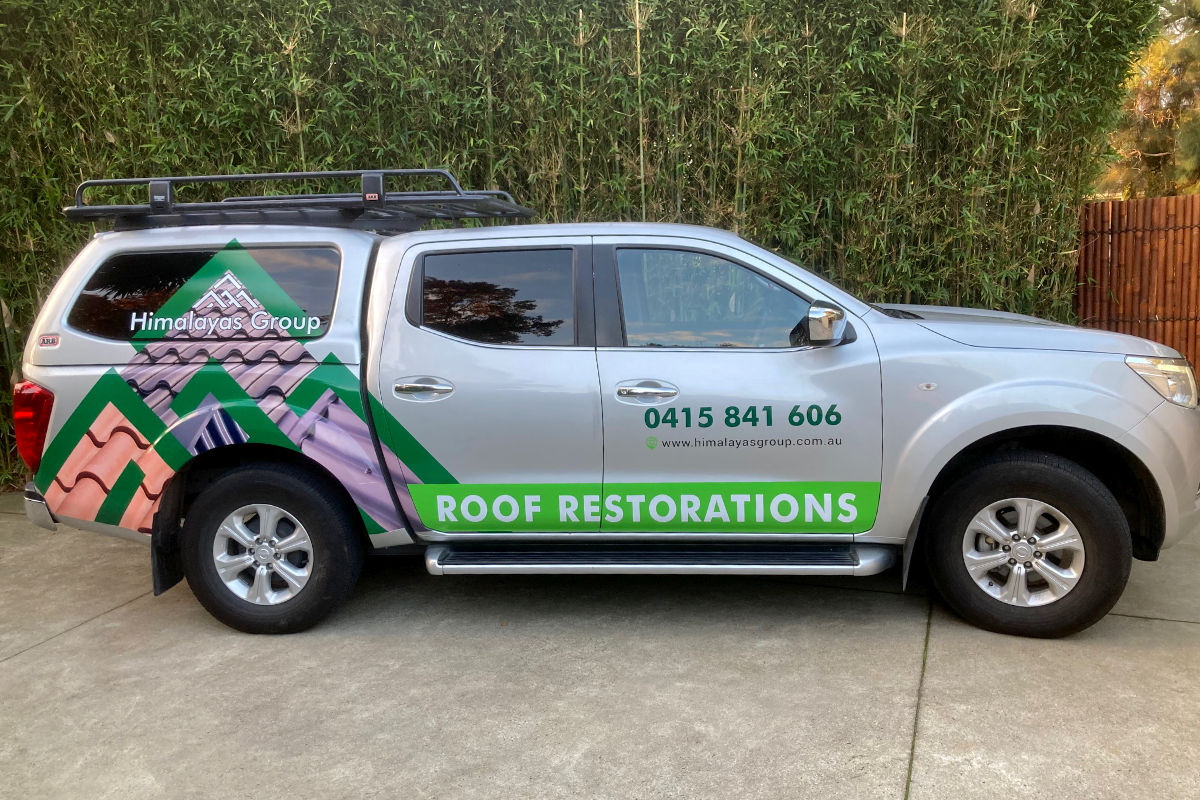 Roof restorations ute with signage by Signspec